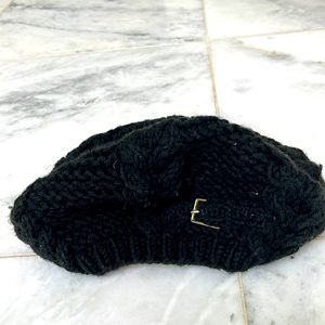 Black wool beret with gold buckle detail.
